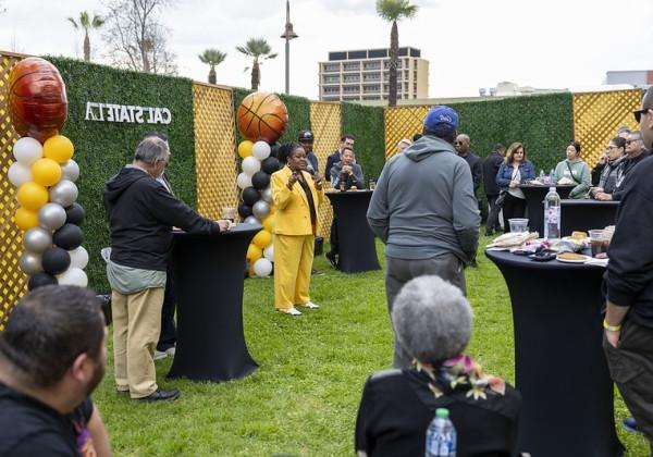 Cal State LA alumni and community gathered around President Eanes as she speaks. 