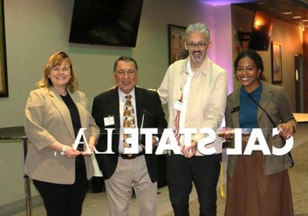 Guests posing for photo at Educators' Mixer