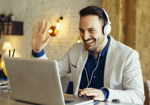 Male videochatting and waving